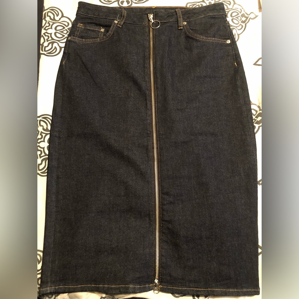Denim skirt with zipper down the front and pockets in the back.